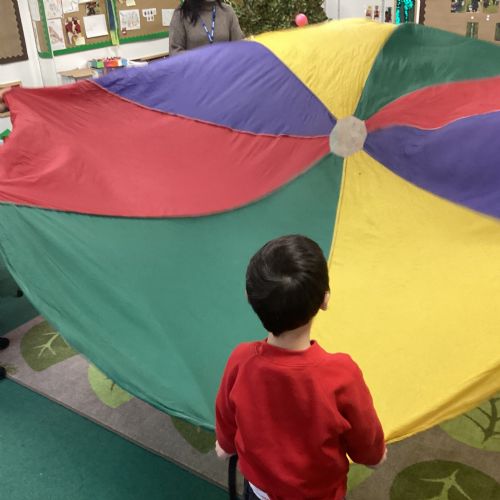 Building up our muscles by enjoying mark making, parachute games and sports in the hall.